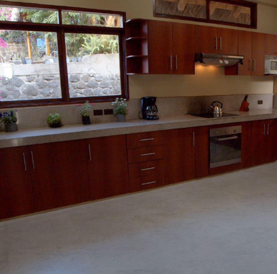 kitchen with gray floor, large window and brown cabinets